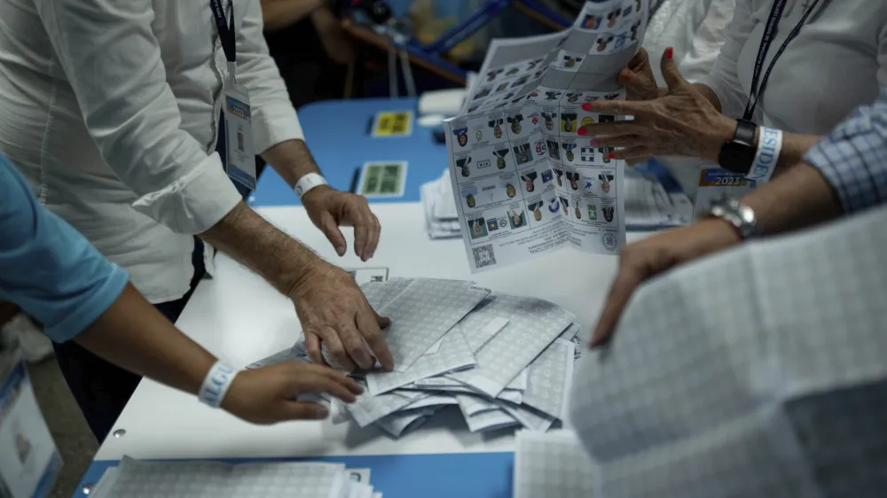 Electoral workers count ballots after the polls closed during general elections in Guatemala City, Sunday, June 25, 2023. (AP Photo/Santiago Billy)