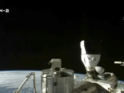 In this image from NASA TV, the sun rises over the International Space Station after a SpaceX capsule docked, Monday, May 22, 2023. The space station rolled out the welcome mat for two Saudi visitors, including the kingdom's first female astronaut. (NASA TV via AP)