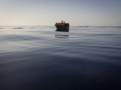 FILE - Migrants with life jackets provided by volunteers of the Ocean Viking, a migrant search and rescue ship run by NGOs SOS Mediterranee and the International Federation of Red Cross (IFCR), still sail in a wooden boat as they are being rescued, on Aug. 27,&nbsp;2022. The border and coast guard agency Frontex estimated that more than 50,300 attempts were made to enter the EU without authorization from January to May. It's more than double the number in the same period last year, and the most since 2017. (AP Photo/Jeremias Gonzalez, File)