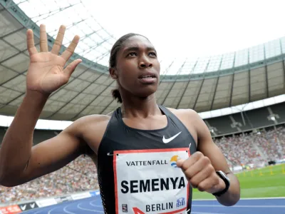 FILE - This Aug. 22, 2010, file photo shows Caster Semenya of South Africa gesturing after winning the women's 800 meter final of the ISTAF Athletics Meeting at the Olympic stadium in Berlin, Germany. The International Olympic Committee has agreed to adopt rules for dealing with cases of female athletes who have excessive levels of male hormones. The issue of gender verification gained international prominence after Semenya was ordered to undergo sex tests after winning the 800 meters at the 2009 world championships. (AP Photo/Gero Breloer, File)