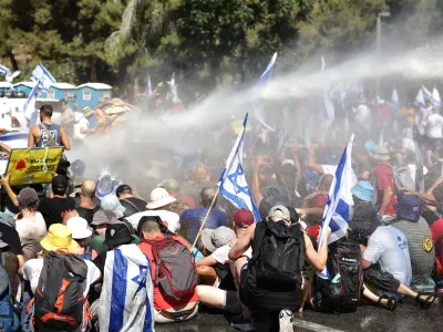 24 July 2023, Israel, Jerusalem: Israeli police use water cannon to disperse demonstrators blocking the road leading to the Knesset, as Israel's parliament was expected to take a final vote on a key element of the government's controversial plans to restructure the judiciary. Photo: Ilia yefimovich/dpa