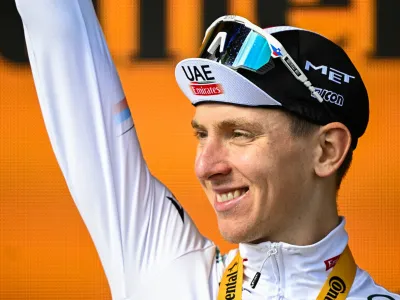22 July 2023, France, Le Markstein Fellering: Slovenian cyclist Tadej Pogacar of UAE Team Emirates celebrates on the podium after winning the 20th stage of the 110th edition of the Tour de France cycling race, 133,5 km from Belfort to Le Markstein Fellering. Photo: David Pintens/Belga/dpa