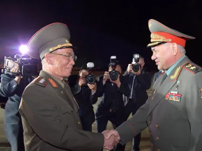 HANDOUT - 25 July 2023, North Korea, Pyongyang: A photo released by the North Korean state news agency (KCNA) on 26 July 2023 shows North Korean Defence Minister Kang Sun-nam (L) receiving Russian Defence Minister Sergey Shoigu (R) upon his arrival at an airport in North Korea's capital Pyongyang. According to official information, Russia's Defence Minister Sergei Shoigu has visited neighbouring North Korea for a three-day visit. Photo: -/KCNA/KNS/dpa - ATTENTION: editorial use only and only if the credit mentioned above is referenced in full