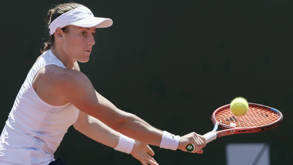 Tamara Zidansek from Slovenia returns a ball to Clara Burel from France during the final match at the tennis WTA International Ladies open in Lausanne, Switzerland, Sunday, July 18, 2021. (Cyril Zingaro/Keystone via AP)