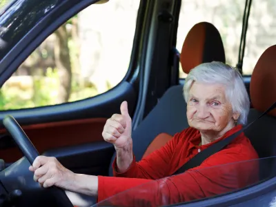 Picture of a confident senior woman driving a car