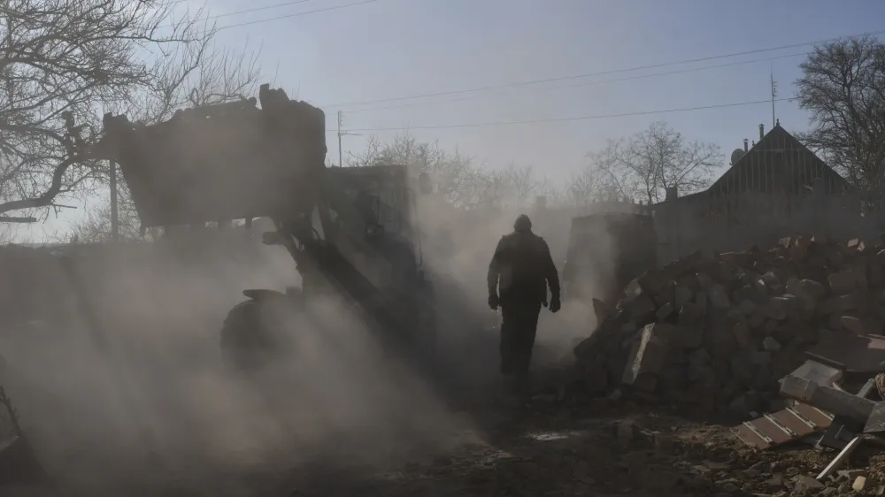 Local residents clear the rubble of a private house following a Russian rocket attack in Komyshevakha in Zaporizhzhya region, Ukraine, Friday, Feb. 10, 2023. (AP Photo/Andriy Andriyenko)