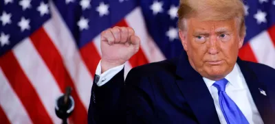 FILE PHOTO: U.S. President Donald Trump raises his fist as he reacts to early results from the 2020 U.S. presidential election in the East Room of the White House in Washington, U.S., November 4, 2020. REUTERS/Carlos Barria/File Photo