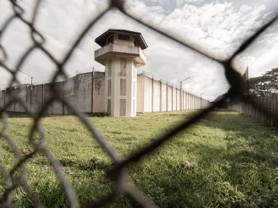 Prison with iron fences.Prison or jail is a building where people are forced to live if their freedom has been taken away.Prison is the building use for punishment prisoner.