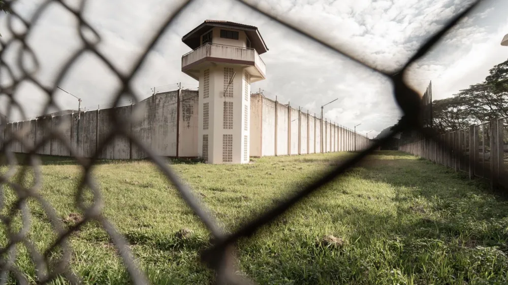 Prison with iron fences.Prison or jail is a building where people are forced to live if their freedom has been taken away.Prison is the building use for punishment prisoner.