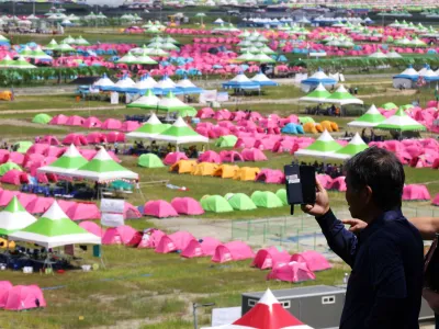 A resident films the camping site for the 25th World Scout Jamboree in Buan, South Korea, August 4, 2023.  REUTERS/Kim Hong-Ji