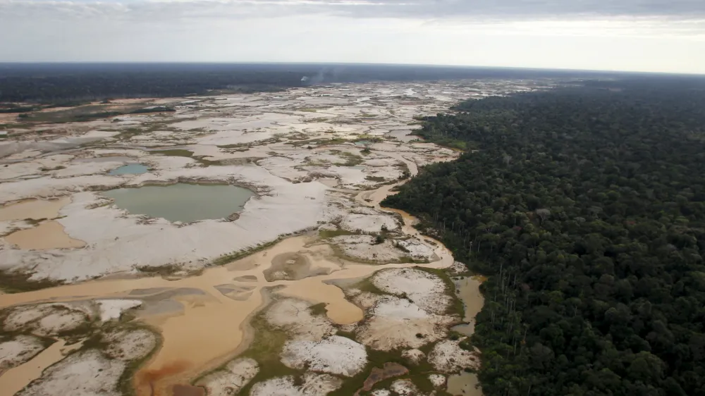 An area deforested by illegal gold mining is seen in a zone known as Mega 14, in the southern Amazon region of Madre de Dios July 13, 2015. Peruvian police razed dozens of illegal gold mining camps at the edge of an Amazonian nature reserve this week, part of a renewed bid to halt the spread of wildcatting in a remote rainforest region. The stings at the edge of the Tambopata National Reserve were the first in the southeastern region of Madre de Dios since a crackdown let up in December. Production from wildcat miners in Madre de Dios, who sell their ore up the supply chain, made up about 10 percent of national production before President Ollanta Humala launched the harshest crackdown yet on illegal gold mining last year. Picture taken July 13, 2015. REUTERS/Janine Costa   TPX IMAGES OF THE DAY   - GF10000160494