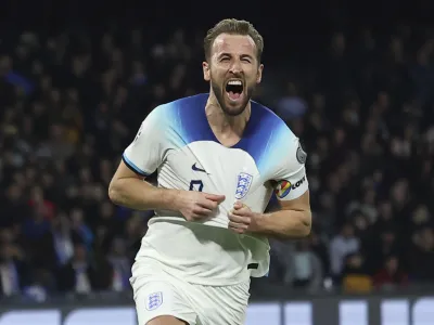 FILE - England's Harry Kane celebrates after scoring to 0-2 during the Euro 2024 group C qualifying soccer match between Italy and England at the Diego Armando Maradona stadium in Naples, Italy, Thursday, March 23, 2023. Harry Kane has a career-defining decision to make. The England captain must choose whether to stay at Tottenham or move to German giant Bayern Munich. The clubs reportedly have reached an agreement regarding the transfer of Kane for a deal worth more than 100 million euros (0 million) and now it is over to the striker to decide. (Alessandro Garofalo/Lapresse via AP, File)