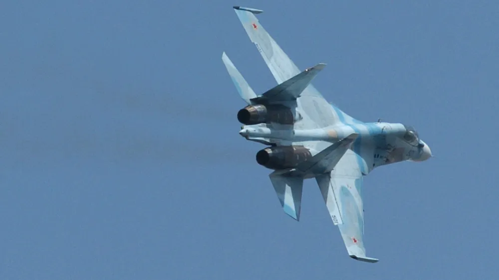 A Russian Sukhoi SU-30 fighter jet flies during Venezuela's independence day military parade in Fort Tiuna in Caracas, Venezuela, Wednesday, July 5, 2006. Venezuela has bought 100,000 Russian-made AK-103 assault rifles, 15 Russian military helicopters and wants to close a deal for 24 Sukhoi fighter jets, when Chavez travels to Moscow later this month. (AP Photo/Gregorio Marrero)
