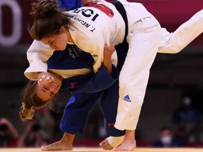 Tokyo 2020 Olympics - Judo - Women's 57kg - Repechage Round - Nippon Budokan - Tokyo, Japan - July 26, 2021. Kaja Kajzer of Slovenia scores ippon against Timna Nelson Levy of Israel REUTERS/Annegret Hilse