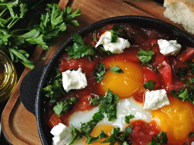 Fried eggs with vegetables and feta cheese. Shakshuka. Keto diet. Keto breakfast or snack. Middle Eastern style.