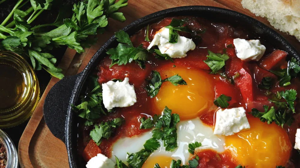 Fried eggs with vegetables and feta cheese. Shakshuka. Keto diet. Keto breakfast or snack. Middle Eastern style.