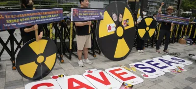 Members of environmental civic groups shout slogans during a rally to denounce the Japanese government's decision to release treated radioactive water into the sea from the damaged Fukushima nuclear power plant, outside of a building which houses Japanese Embassy, in Seoul, South Korea, Tuesday, Aug. 22, 2023. Japan will start releasing treated and diluted radioactive wastewater from the Fukushima Daiichi nuclear plant into the Pacific Ocean as early as Thursday, a controversial but essential early step in the decades of work to shut down the facility 12 years after its meltdown disaster. (AP Photo/Lee Jin-man)