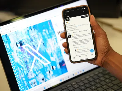 24 July 2023, United Kingdom, London: A person looks at the new logo for Twitter on an Apple iPhone in an office in London. Twitter has replaced the social media platform's famous bird logo with an X as part of owner Elon Musk's plans to create an "everything app". Photo: Jonathan Brady/PA Wire/dpa
