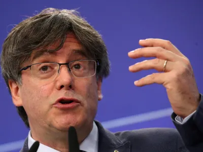FILE PHOTO: Catalan MEP Carles Puigdemont gestures during a joint news conference with Catalan MEPs Antoni Comin and Clara Ponsati regarding their immunity at the European Parliament, in Brussels, Belgium June 3, 2021. REUTERS/Yves Herman/File Photo