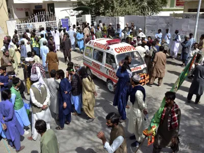 People gather at a hospital, where injured victims of a bomb explosion are brought, in Quetta, Pakistan, Friday, Sept. 29, 2023. A powerful bomb exploded at a rally celebrating the birthday of Islam's Prophet Muhammad in southwest Pakistan on Friday, killing multiple people and wounding dozens of others, police and a government official said. (AP Photo/Arshad Butt)