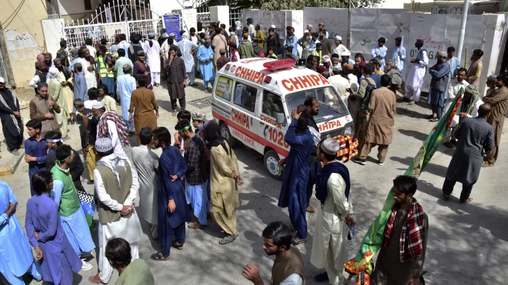 People gather at a hospital, where injured victims of a bomb explosion are brought, in Quetta, Pakistan, Friday, Sept. 29, 2023. A powerful bomb exploded at a rally celebrating the birthday of Islam's Prophet Muhammad in southwest Pakistan on Friday, killing multiple people and wounding dozens of others, police and a government official said. (AP Photo/Arshad Butt)
