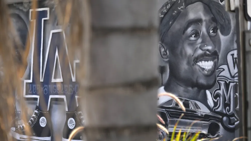 A portion of a mural by artist sloe_motions depicting Tupac Shakur is seen on the side of Speedy Auto Tint on Friday, Sept. 29, 2023, in Bellflower, Calif. (AP Photo/Chris Pizzello)