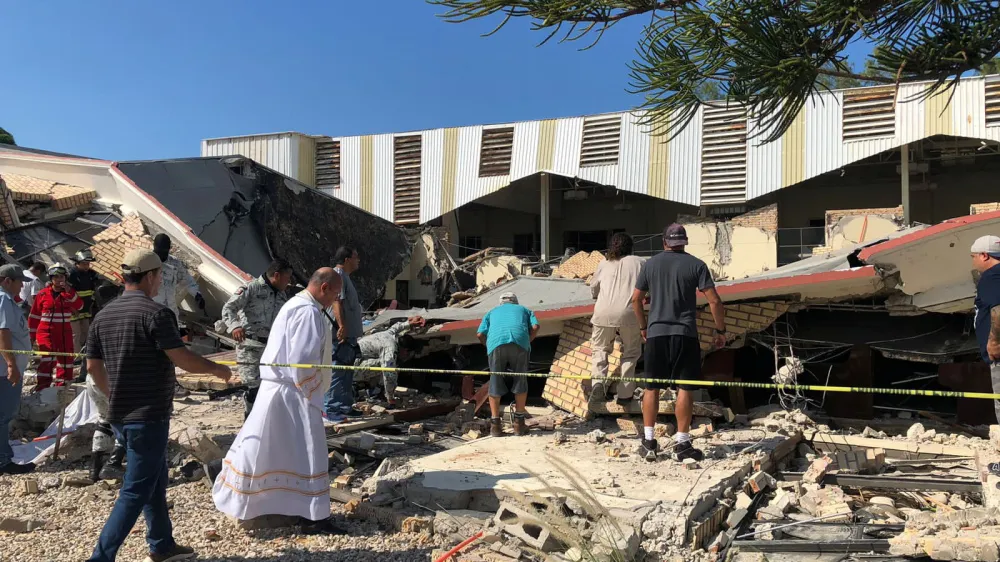 Members of security forces, people and a priest work at a site where a church roof collapsed during Sunday mass in Ciudad Madero, in Tamaulipas state, Mexico in this handout picture distributed to Reuters on October 1, 2023. Secretaria de Seguridad Publica Tamaulipas/Handout via REUTERS THIS IMAGE HAS BEEN SUPPLIED BY A THIRD PARTY. NO RESALES. NO ARCHIVES