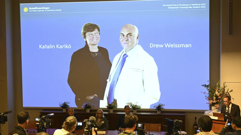 Thomas Perlmann, secretary of the Nobel Assembly, right, announces the winner of the 2023 Nobel Prize in Physiology or Medicine to Katalin Karik&oacute; and Drew Weissman, seen on screen, at the Karolinska Institute in Stockholm, Monday Oct. 2, 2023. The Nobel Prize in medicine has been awarded to Katalin Karik&oacute; and Drew Weissman for discoveries that enabled the development of effective mRNA vaccines against COVID-19.(Jessica Gow/TT News Agency via AP)