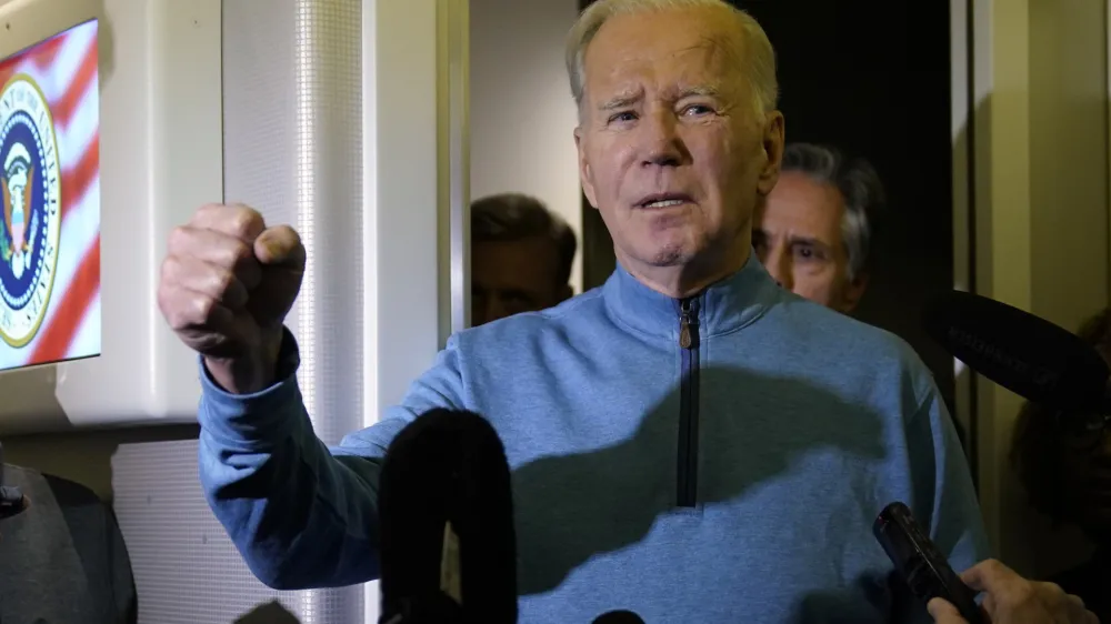 President Joe Biden talks to reporters aboard Air Force One during a refueling stop in at Ramstein Air Base in Germany, Wednesday, Oct. 18, 2023, as he travels back from Israel to Washington. (AP Photo/Evan Vucci)
