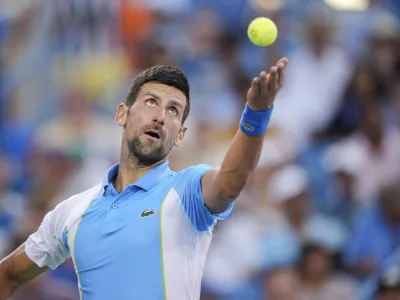 Novak Djokovic, of Serbia, serves to Carlos Alcaraz, of Spain, during the men's singles final of the Western & Southern Open tennis tournament, Sunday, Aug. 20, 2023, in Mason, Ohio. (AP Photo/Aaron Doster)