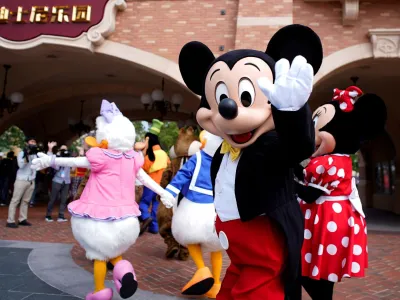 FILE PHOTO: Disney character Mickey Mouse greets visitors at Shanghai Disney Resort as the Shanghai Disneyland theme park reopens following a shutdown due to the coronavirus disease (COVID-19) outbreak, in Shanghai, China May 11, 2020. REUTERS/Aly Song/File Photo