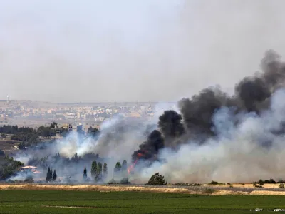 Smoke rises from a fire as a result of fighting in the the Syrian village of Quneitra near the border with Israel, as seen from an observatory near the Quneitra crossing, Thursday, June 6, 2013. Syrian rebels on Thursday captured a crossing point along a cease-fire line with Israel in the contested Golan Heights, a development that could deepen Israeli concerns over the growing role of Islamic radicals in the civil war near its northern frontier.(AP Photo/Sebastian Scheiner)