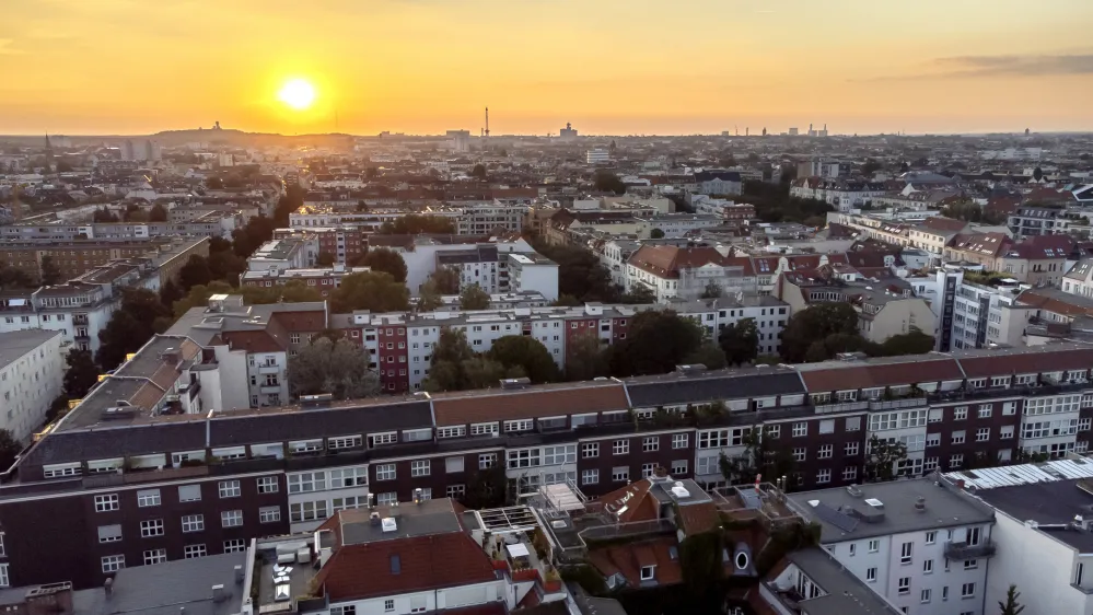 FILE - In this Sept. 7, 2021 file photo the sun goes down behind apartment houses in Berlin, Germany. Berlin's city government said Friday it is buying some 14,750 apartments from two large corporate landlords for 2.46 billion euros ($2.9 billion) &mdash; a deal announced a week before local and national elections as the German capital tries to expand the supply of publicly owned accommodation. (AP Photo/Michael Sohn, File)