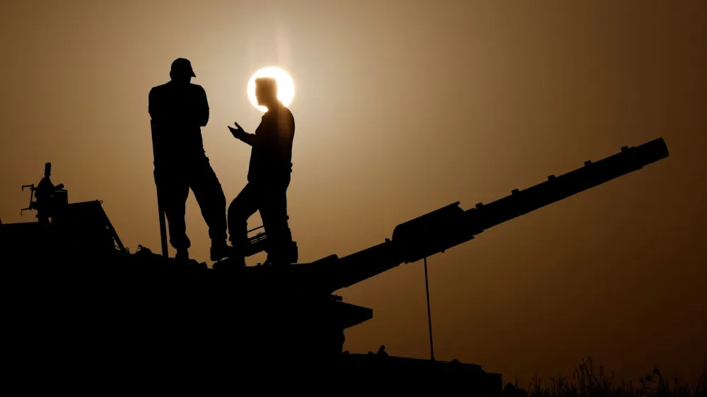 Israeli soldiers stand on a tank, amid the ongoing conflict between Israel and the Palestinian group Hamas, near Israel's border with Gaza in southern Israel, November 23, 2023. REUTERS/Amir Cohen