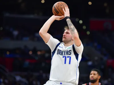 Nov 25, 2023; Los Angeles, California, USA; Dallas Mavericks guard Luka Doncic (77) shoots against the Los Angeles Clippers during the second half Crypto.com Arena. Mandatory Credit: Gary A. Vasquez-USA TODAY Sports