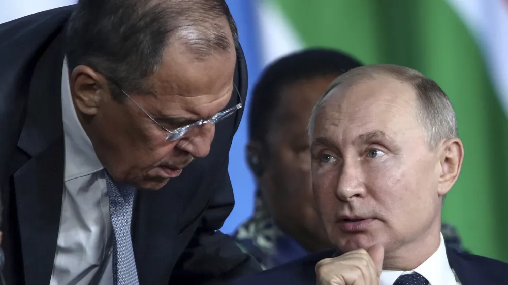 FILE - Russian President Vladimir Putin, right, listens to Russian Foreign Minister Sergey Lavrov, top, as Egyptian President Abdel Fattah el-Sisi sits next during a plenary session at the Russia-Africa summit in the Black Sea resort of Sochi, Russia, Oct. 24, 2019. In his role for nearly 18 years, Lavrov, 71, has seen relations with the West shift from near-friendly to openly hostile, plummeting to a catastrophic new low with the Russian war against Ukraine. The invasion prompted the European Union to freeze the assets of both Putin and Lavrov, among others &acirc;&euro;" an unprecedented blow to Moscow's pride. (Valery Sharifulin, TASS News Agency Pool Photo via AP, File)