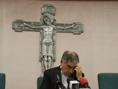 FILE - Cardinal Angelo Becciu talks to journalists during a press conference in Rome, Friday, Sept. 25, 2020. Lawyers for the once-powerful cardinal have accused Vatican prosecutors of being "prisoners to their completely shattered theory" in closing arguments of a two-year trial. Becciu is on trial along with nine other people in&nbsp;a case&nbsp;that is focused on the Vatican's 350 million-euro investment in a London property. (AP Photo/Gregorio Borgia)