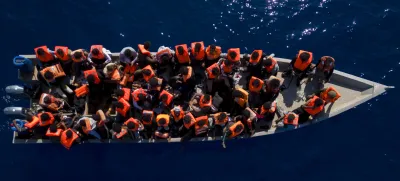 FILE - Migrants from Eritrea, Libya and Sudan sail a wooden boat before being assisted by aid workers of the Spanish NGO Open Arms, in the Mediterranean sea, about 30 miles north of Libya, Saturday, June 17, 2023. Ministers from Germany and France tasked with regulating migration are joining forces to try to curb deaths on dangerous routes across the Mediterranean Sea. The interior ministers are traveling Sunday for talks with the president and their counterpart in Tunisia, a major North African stepping stone for migrants trying to reach Europe at risk of their lives. (AP Photo/Joan Mateu Parra, File)