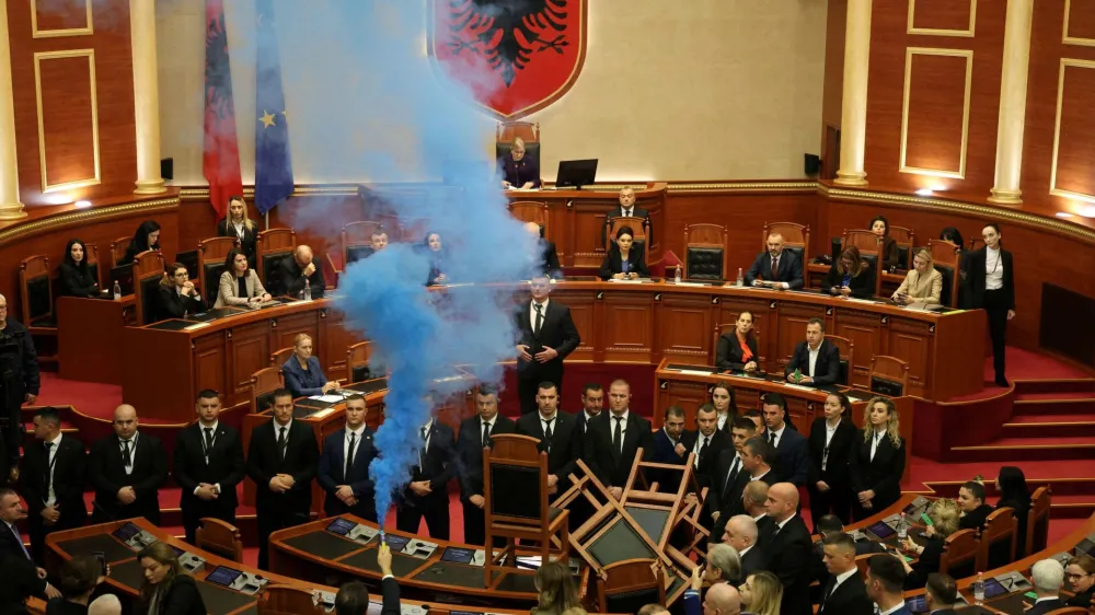 A member of parliament from the Democratic Party, Albania's biggest opposition party, sets off a smoke flare as the parliament gathers for a vote on whether to lift the immunity of opposition leader Sali Berisha so he can face corruption charges, in Tirana, Albania, December 21, 2023 REUTERS/Florion Goga   TPX IMAGES OF THE DAY