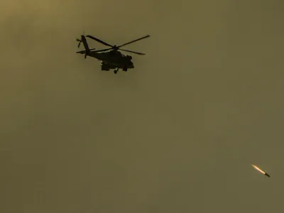 An Israeli Apache helicopter fires a missile in direction of the Gaza Strip, as seen from southern Israel, Friday, Dec. 29, 2023. The army is battling Palestinian militants across Gaza in the war ignited by Hamas' Oct. 7 attack into Israel. (AP Photo/Ariel Schalit)