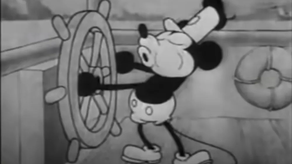 This still image from video provided by Disney shows the character Mickey Mouse in the 1928 animated short "Steamboat Willie." On Monday, Jan. 1, 2024, the iconic character from "Steamboat Willie" entered the public domain after the expiration of the 95-year copyright, and is already the focus of two horror films. (Disney via AP)