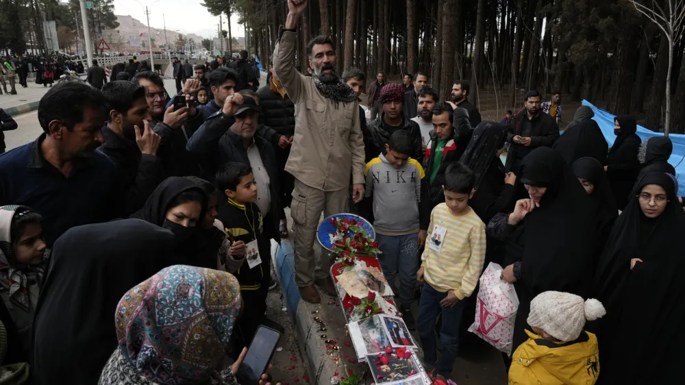 People chant slogans at the scene of Wednesday's bomb explosion in the city of Kerman, about 510 miles (820 kms) southeast of the capital Tehran, Iran, Thursday, Jan. 4, 2024. Investigators believe suicide bombers likely carried out an attack on a commemoration for an Iranian general slain in a 2020 U.S. drone strike, state media reported Thursday, as Iran grappled with its worst mass-casualty attack in decades and as the wider Mideast remains on edge. (AP Photo/Vahid Salemi)