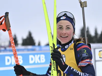 Justine Braisaz-Bouchet of France smiles after crossing a finish line during the Biathlon World Cup women's 7.5 km sprint in Oberhof, Germany, Friday, Jan. 5, 2024. (Martin Schutt/dpa via AP)