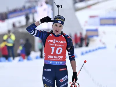 First placed Julia Simon from France celebrates after the women's 10km pursuit race of the Biathlon World Cup in Oberhof, Germany, Saturday, Jan. 6, 2024. (Martin Schutt/dpa via AP)