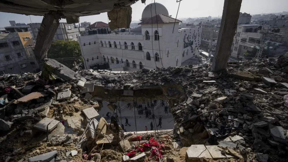 Palestinians look at a damaged residential building after an Israeli strike in Rafah, southern Gaza Strip, Wednesday, Jan. 10, 2024. (AP Photo/Fatima Shbair)
