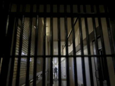 A guard stands behind bars at the Adjustment Center during a media tour of California's Death Row at San Quentin State Prison in San Quentin, California December 29, 2015. America's most populous state, which has not carried out an execution in a decade, begins 2016 at a pivotal juncture, as legal developments hasten the march toward resuming executions, while opponents seek to end the death penalty at the ballot box. To match Feature CALIFORNIA-DEATH-PENALTY/  Picture taken December 29, 2015. REUTERS/Stephen Lam - RTX21EDY