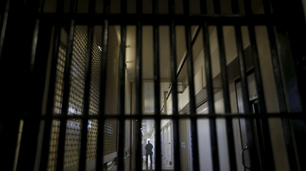 A guard stands behind bars at the Adjustment Center during a media tour of California's Death Row at San Quentin State Prison in San Quentin, California December 29, 2015. America's most populous state, which has not carried out an execution in a decade, begins 2016 at a pivotal juncture, as legal developments hasten the march toward resuming executions, while opponents seek to end the death penalty at the ballot box. To match Feature CALIFORNIA-DEATH-PENALTY/  Picture taken December 29, 2015. REUTERS/Stephen Lam - RTX21EDY