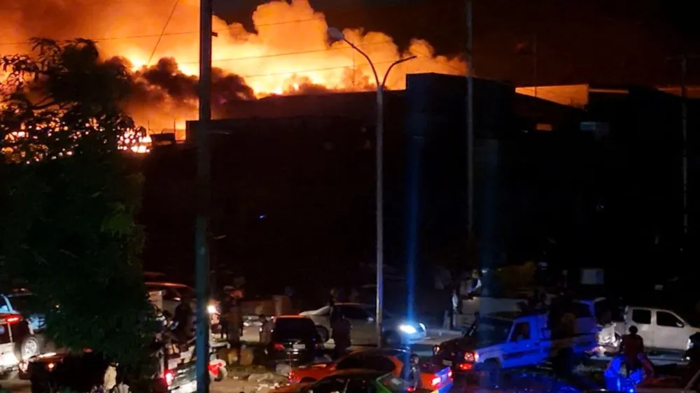 People take part in looting and arson during protests over a pay cut for police that officials blamed on an administrative glitch, in Port Moresby, Papua New Guinea January 10, 2024 in this screen grab obtained from social media video. Leo Manuai/via REUTERS THIS IMAGE HAS BEEN SUPPLIED BY A THIRD PARTY. MANDATORY CREDIT. NO RESALES. NO ARCHIVES.