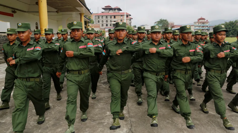 FILE PHOTO: United Wa State Army (UWSA) soldiers march during a display for the media in Pansang, Wa territory in north east Myanmar October 4, 2016. Picture taken October 4, 2016. REUTERS/Soe Zeya Tun/File Photo