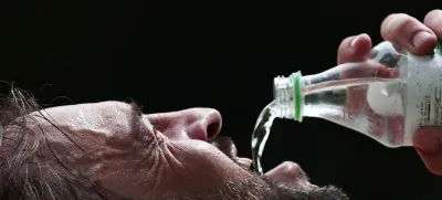 A man drinks water in a park during the summer in Porto Alegre, Brazil, January 8, 2024. REUTERS/Diego Vara